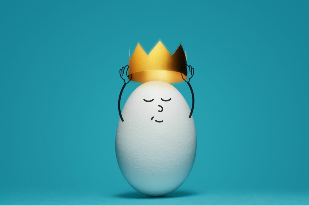 a smiling egg putting on a crown - SUCK-CESS: Detaching From Outcome and Focussing On the Journey